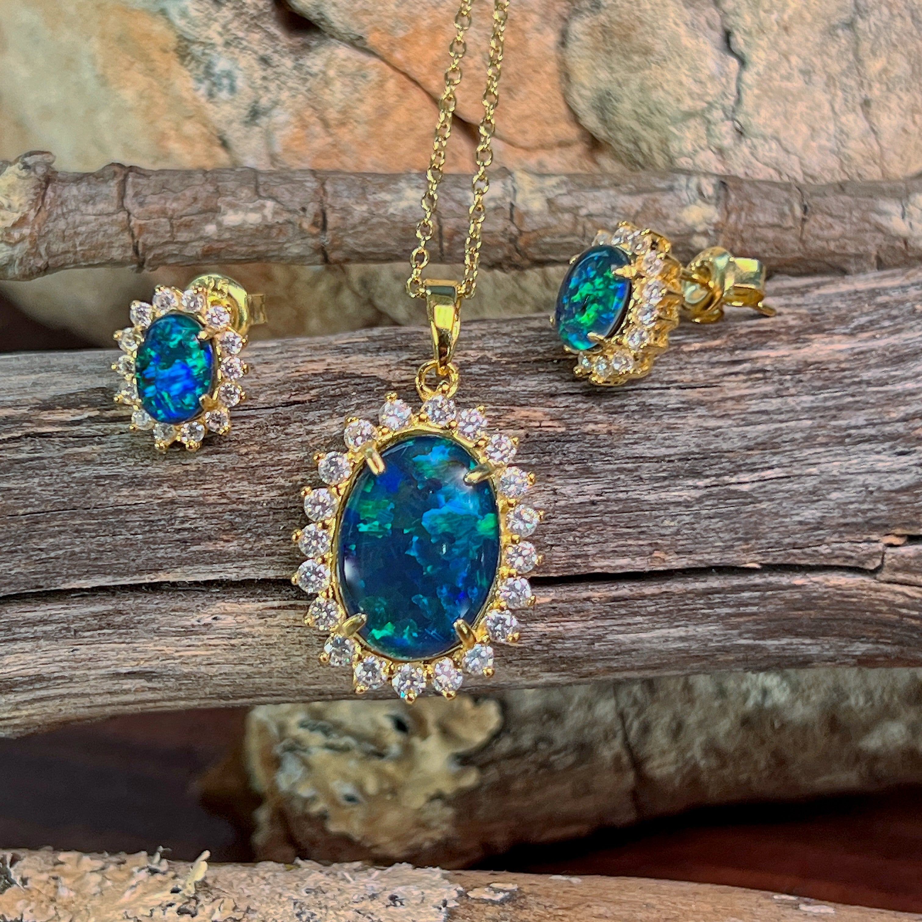 Close view of the 14x10mm opal triplet halo pendant and cluster studs in gold-plated silver