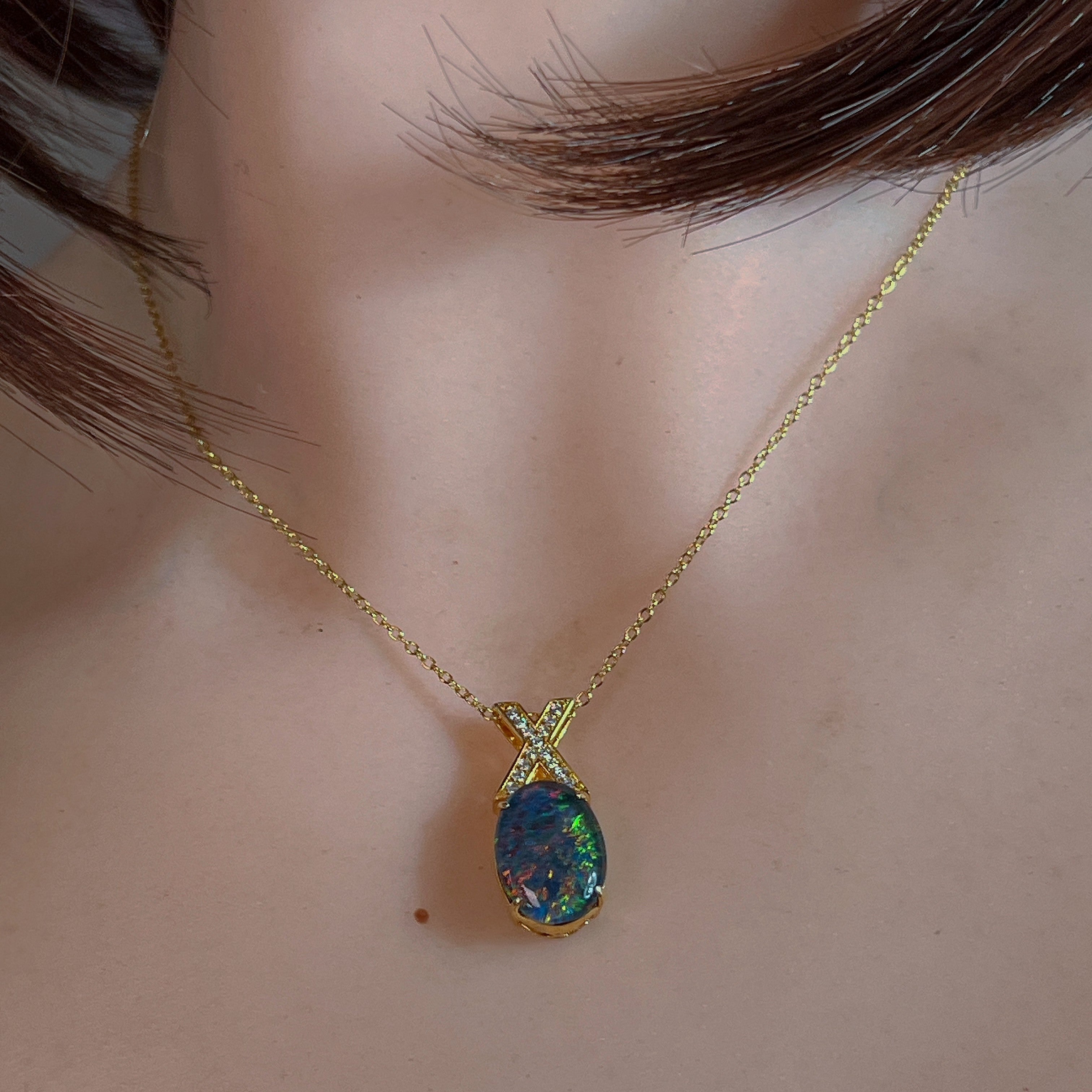 Opal triplet pendant worn at the neck, showing its scale on the collarbone