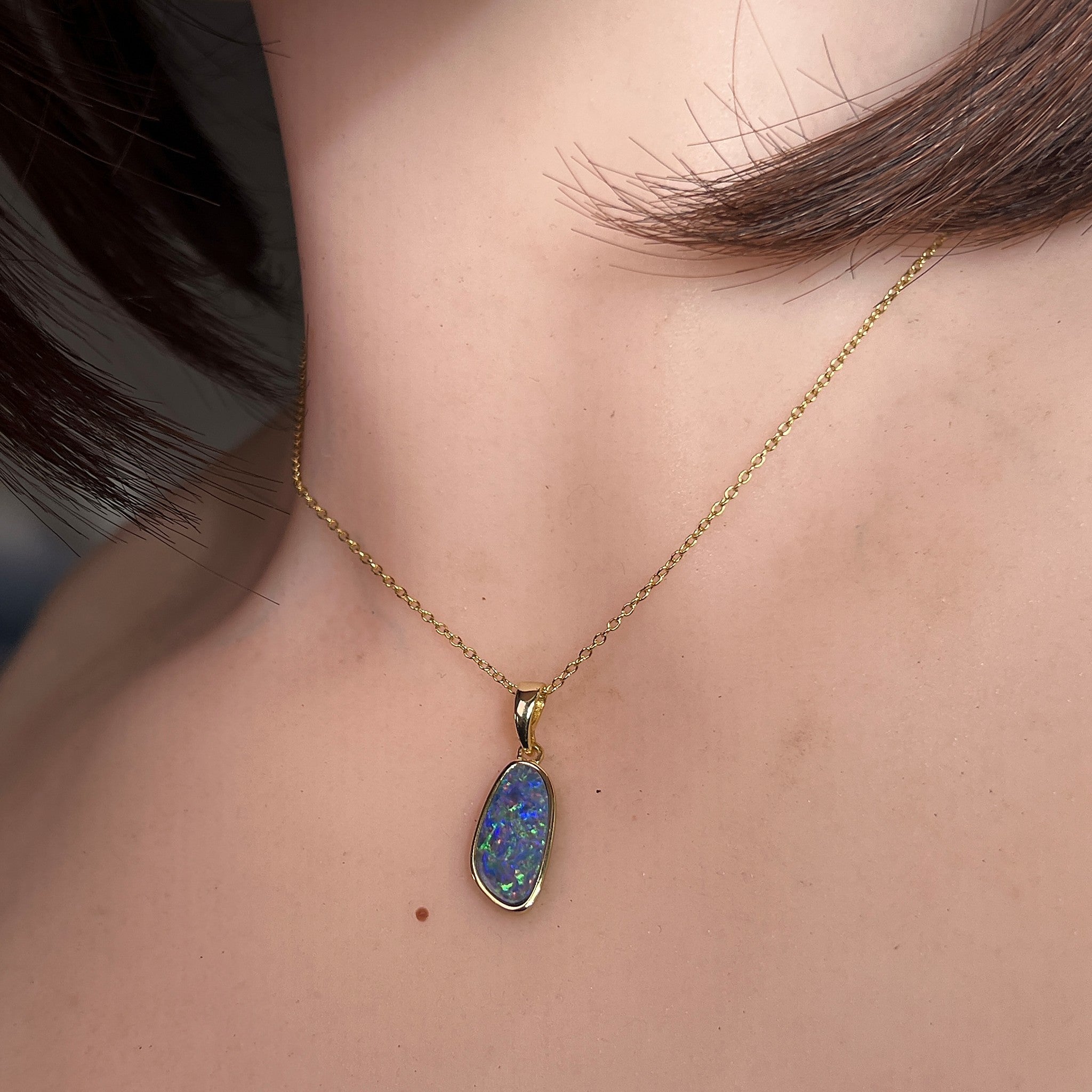Worn Australian opal doublet pendant in yellow gold-plated silver, blue, red and yellow, 15 x 7mm