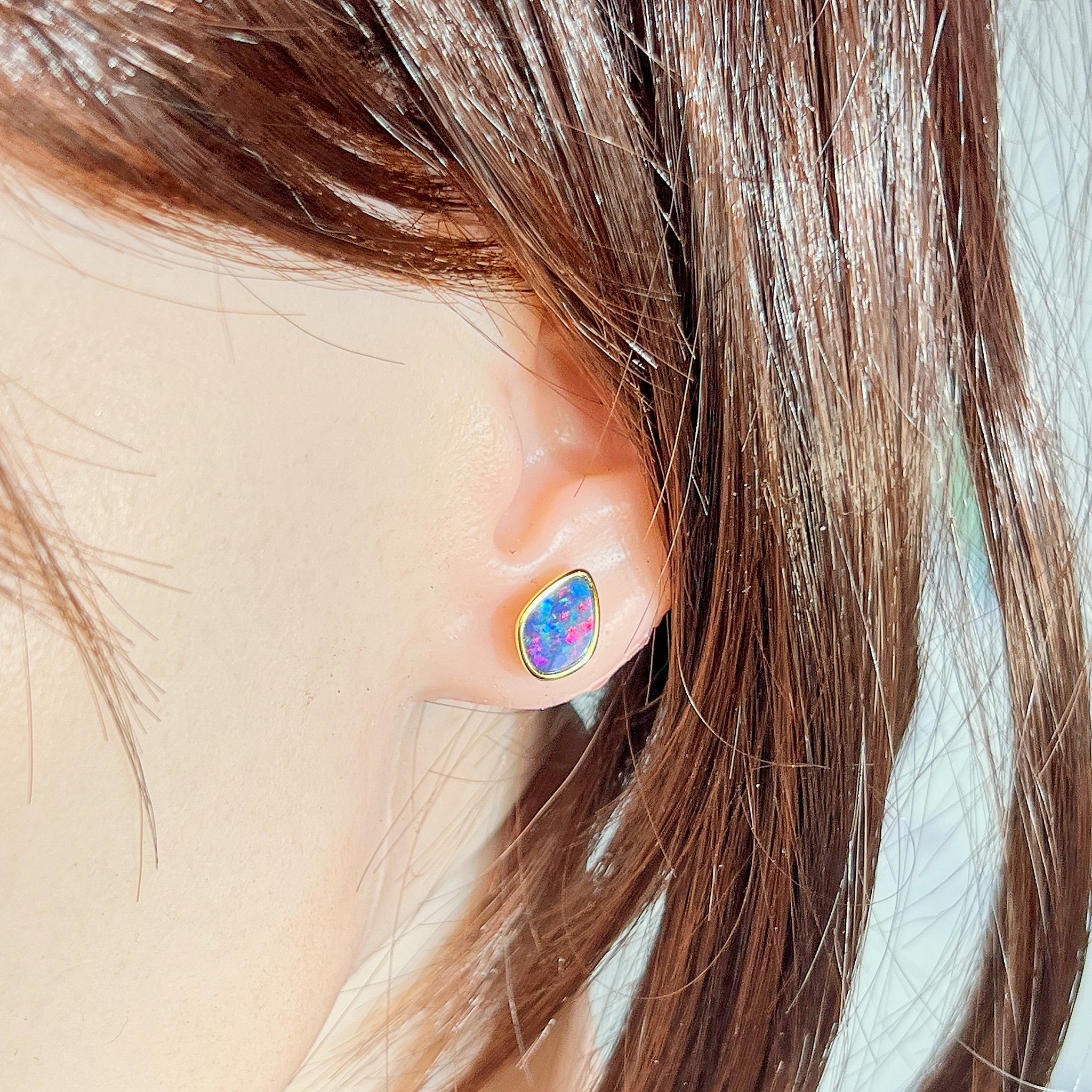 11 x 7.5mm freeform Australian opal doublet earrings worn on the ear, yellow gold-plated silver