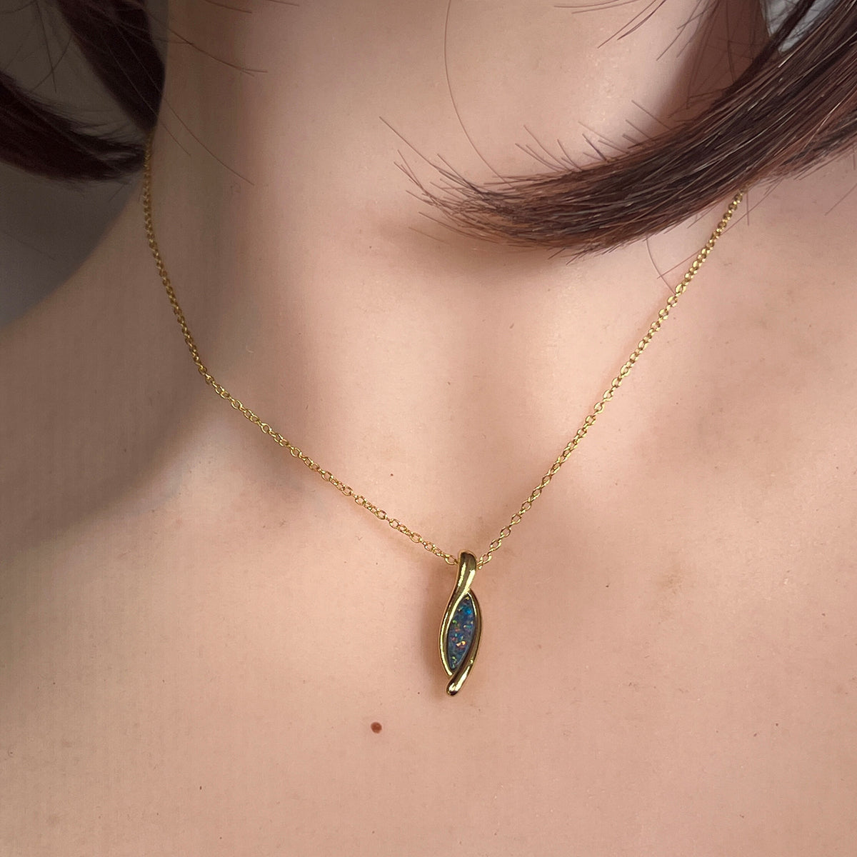12 x 4mm marquise Australian opal doublet pendant worn at the neck, yellow gold-plated silver