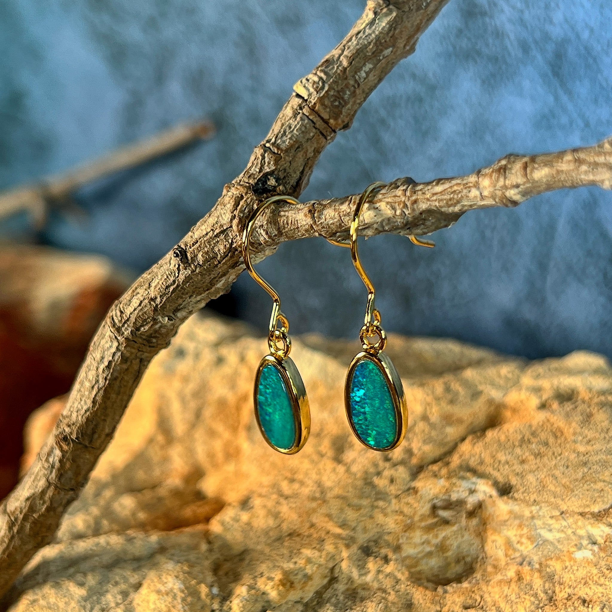 green and yellow play-of-colour in 11 x 6mm oval Australian opal doublet earrings