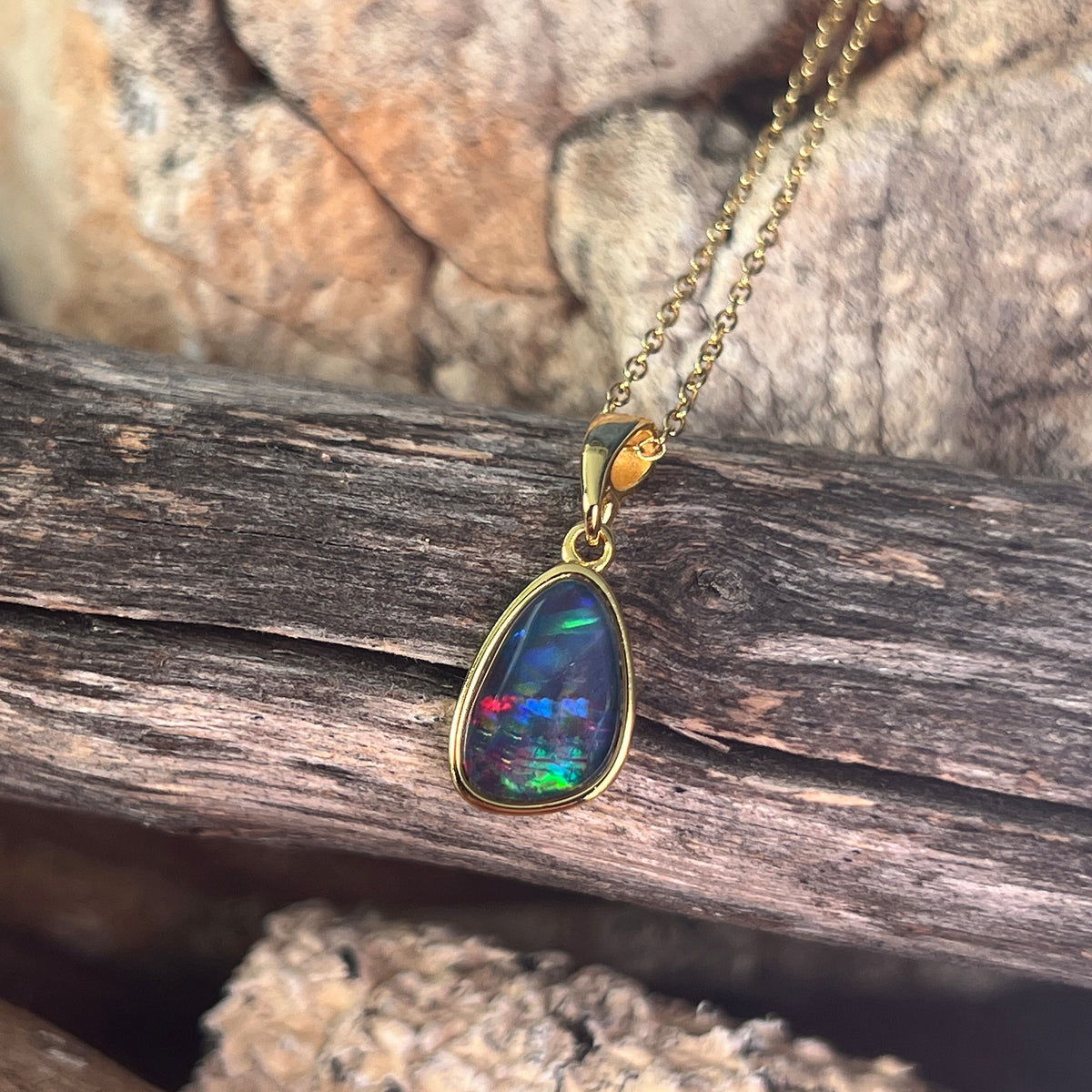 Australian opal triplet pendant, yellow gold-plated silver, 11 x 8mm stone showing red, green and blue