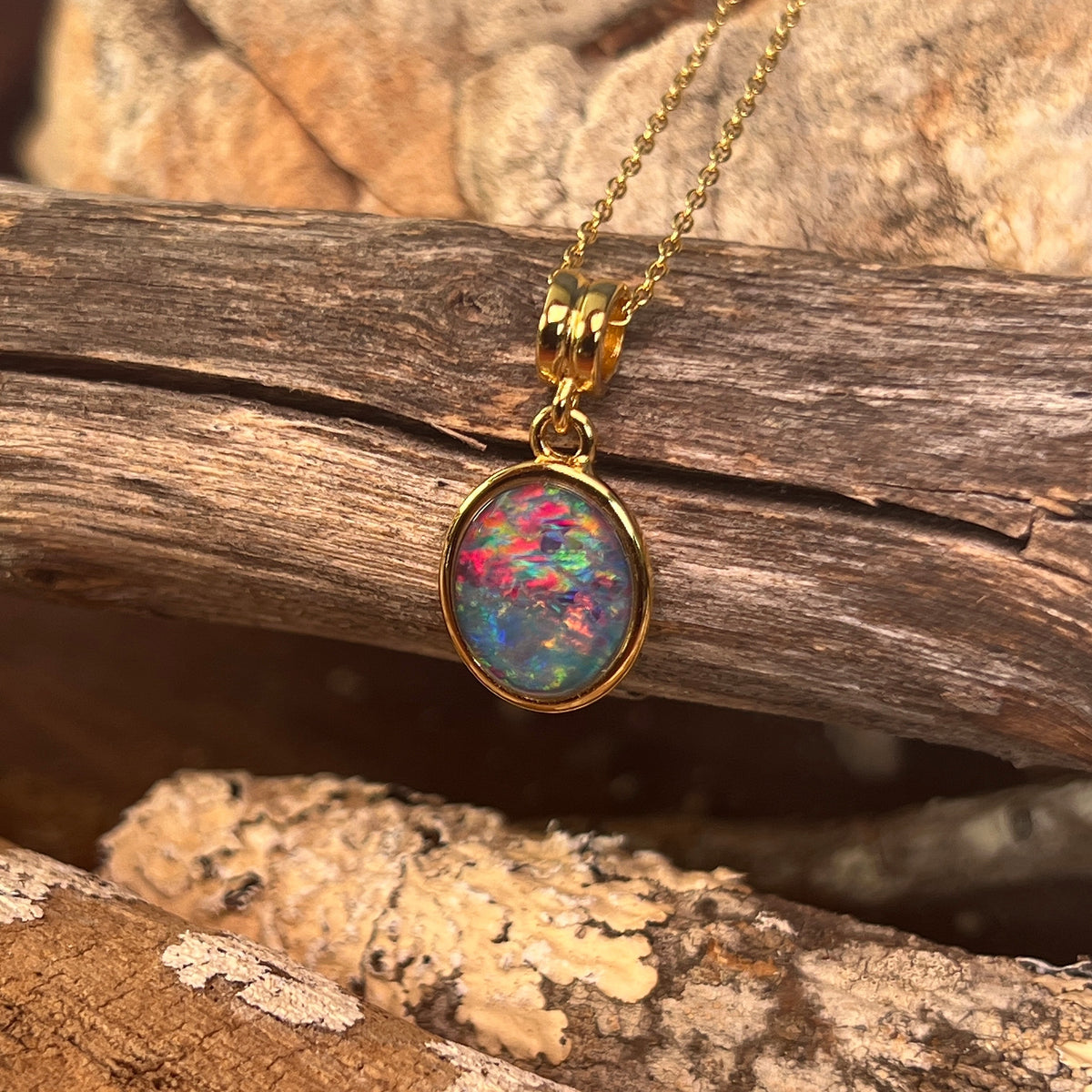 14 x 10mm Australian opal triplet pendant in yellow gold-plated silver, blue, red and green