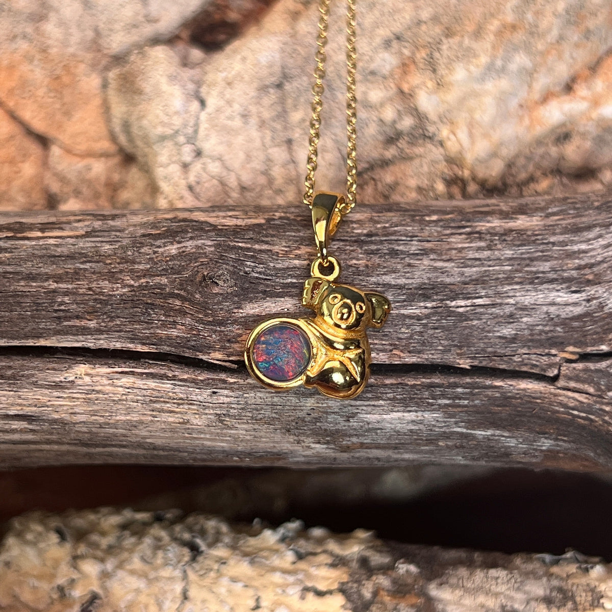 round Australian opal triplet pendant in yellow gold-plated silver, blue, red and green play-of-colour