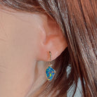 14kt rose gold opal doublet drop earring worn on the ear, showing its scale