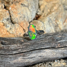 Solid Australian black opal ring, 1.4ct oval stone with green and red flashes in 18kt white gold