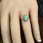 Australian black opal ring on the finger, 1.4ct oval black opal in 18kt white gold