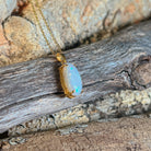 18kt yellow gold pendant with a 2.3ct Australian white opal in a classic oval claw setting