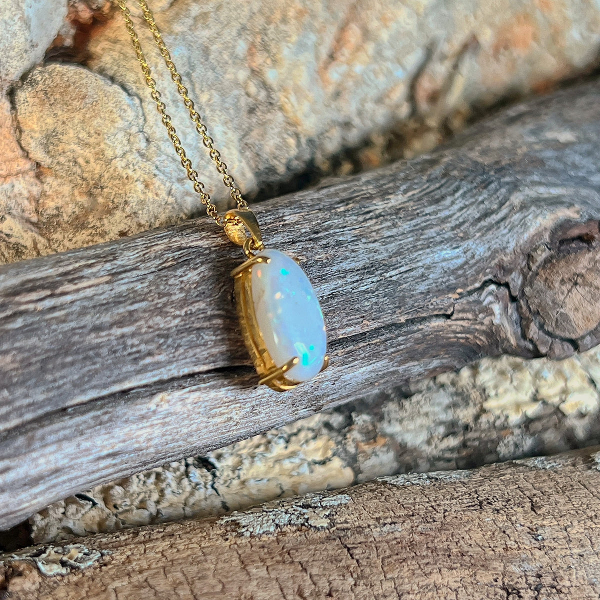 18kt yellow gold pendant with a 2.3ct Australian white opal in a classic oval claw setting