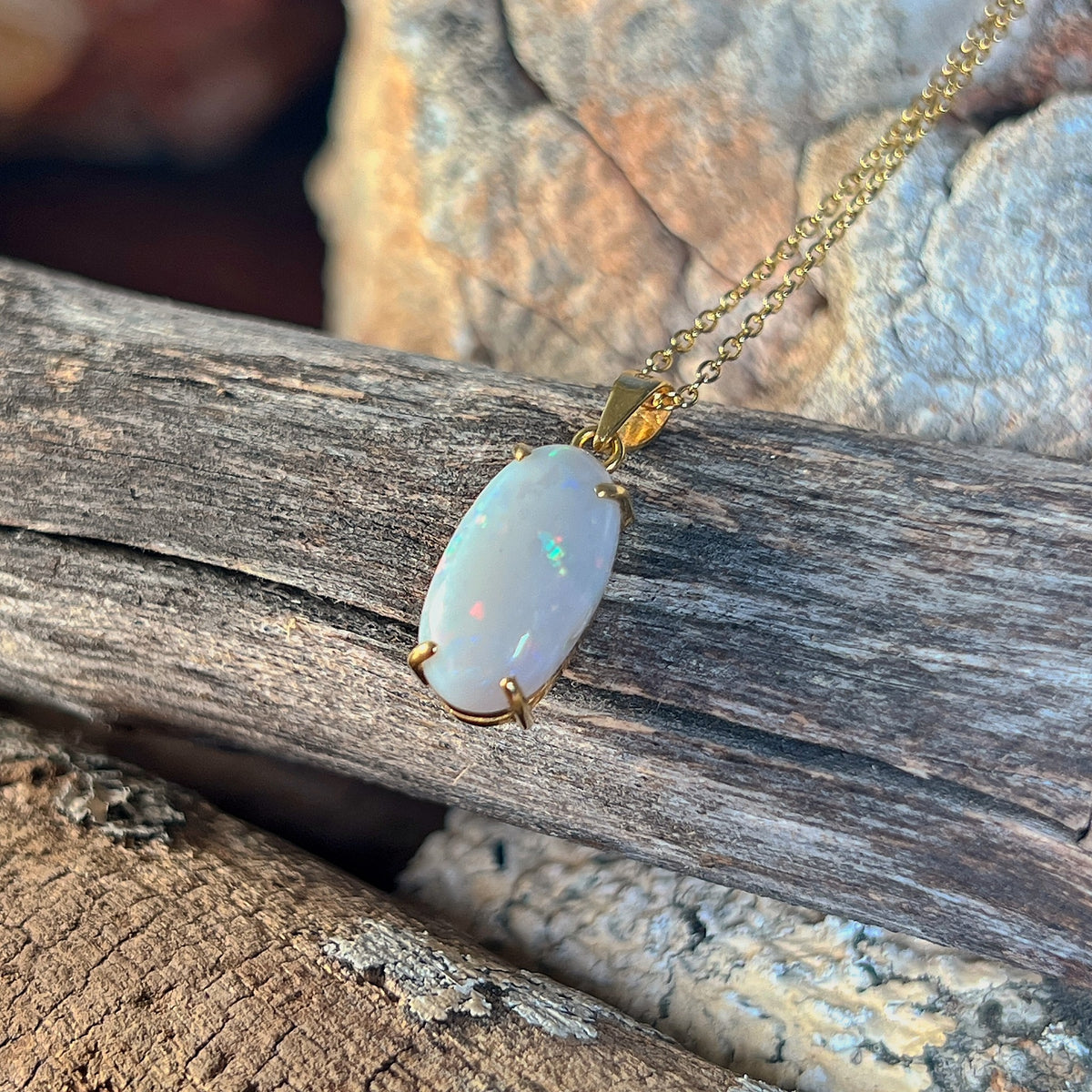 Genuine Australian white opal pendant in 18kt yellow gold, oval stone with blue, red and green colour
