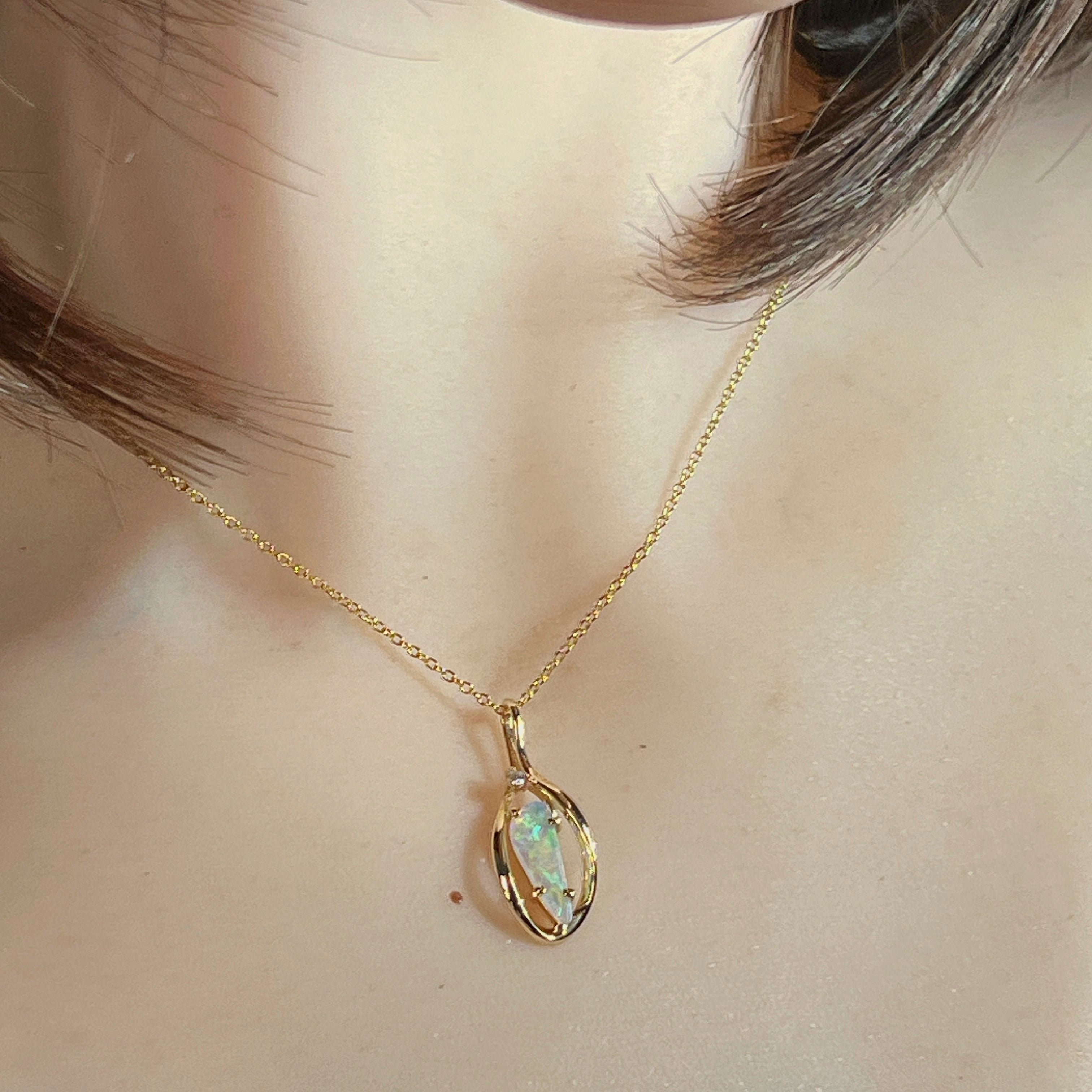 Triangular Australian crystal opal pendant in yellow gold, front view