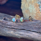 Crystal opal studs in yellow gold showing green and pink play-of-colour