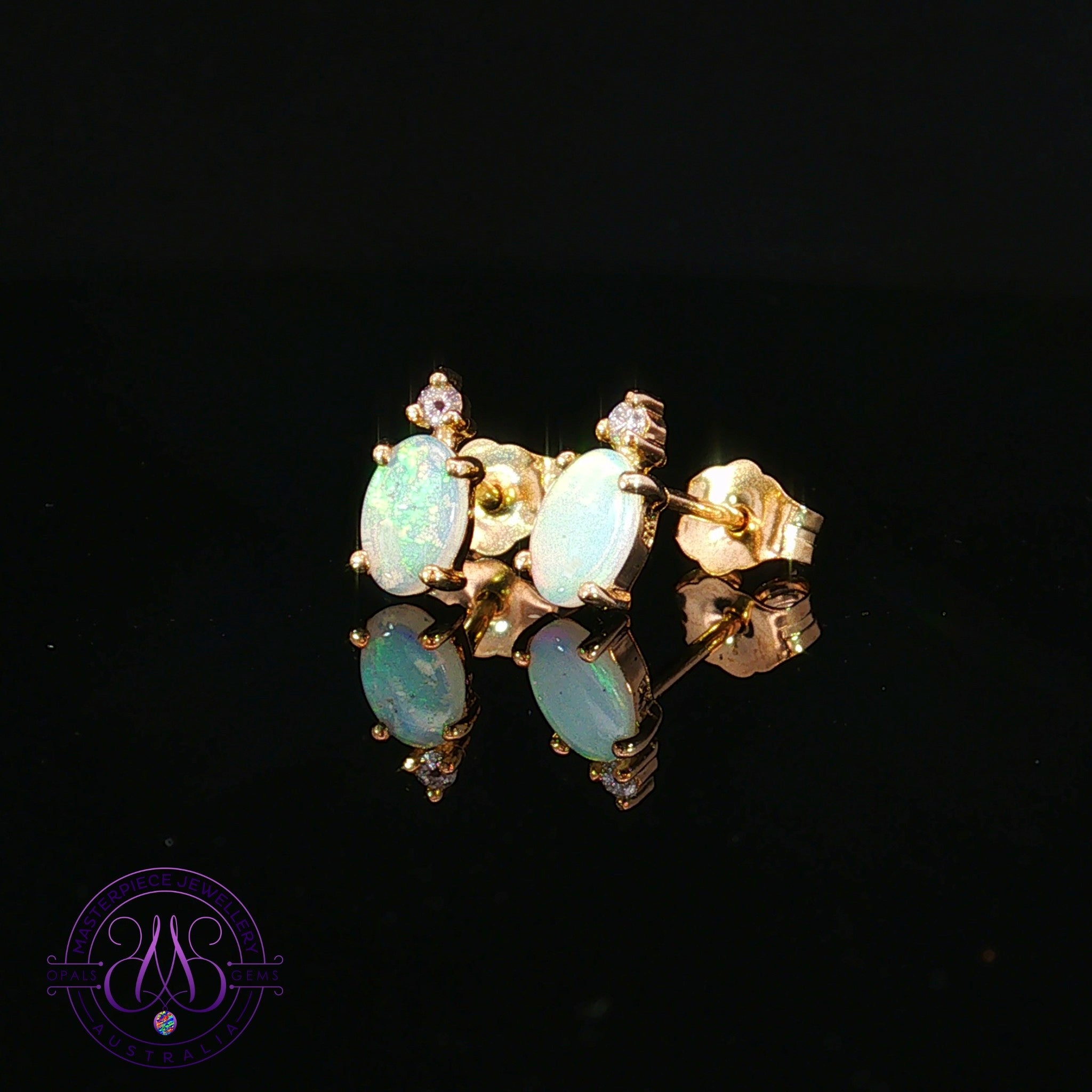 9kt yellow gold stud earrings with 6x4mm oval crystal opals and diamond accents