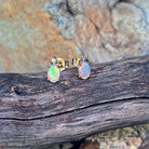 6x4mm oval Australian crystal opals with a diamond above each, in 9kt yellow gold