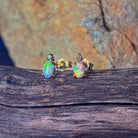Crystal opal oval studs with diamond accents showing green and orange flash