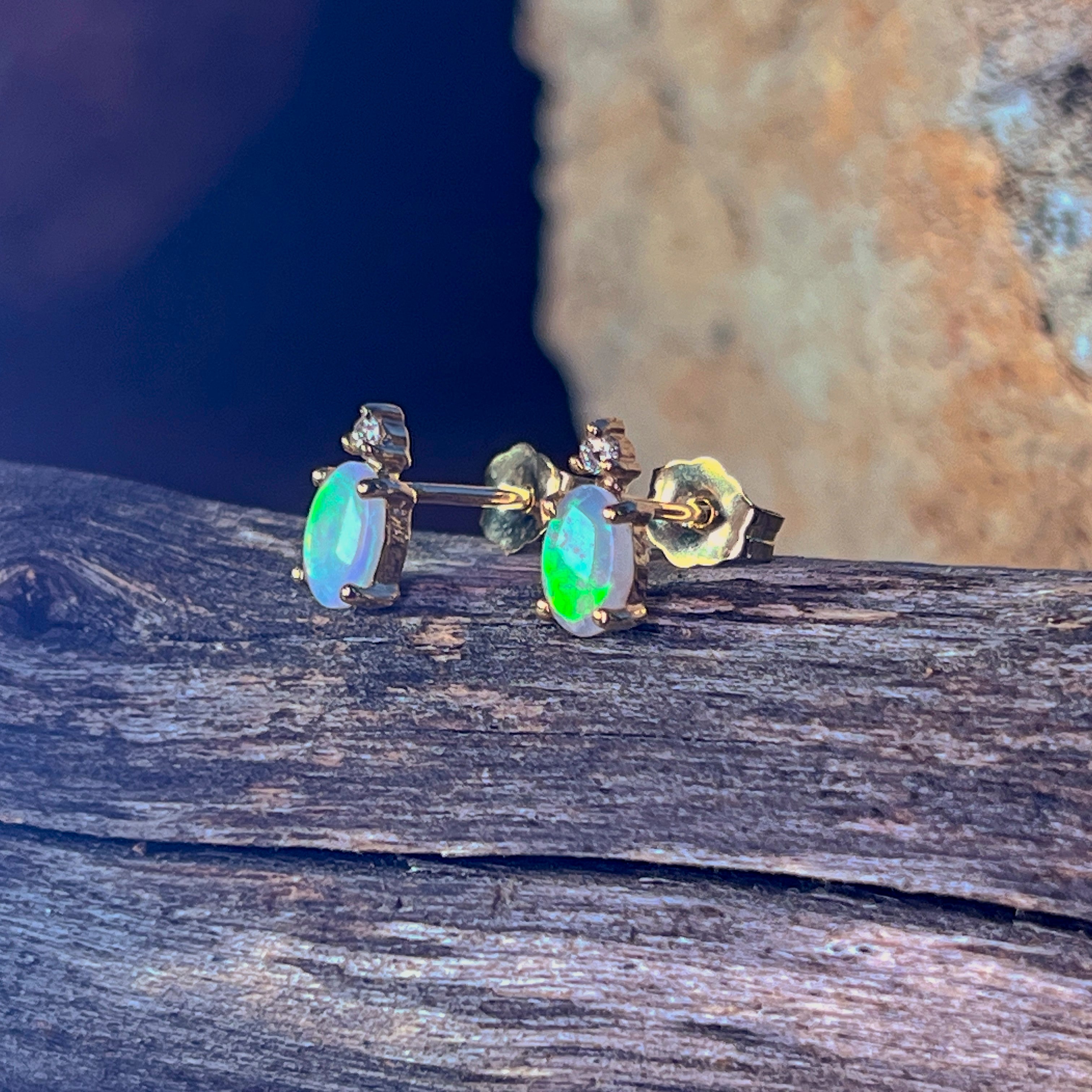 Close view of the diamond accent set above the oval crystal opal