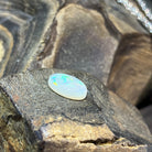 5.56ct white opal cabochon with vivid green pinfire across a creamy body