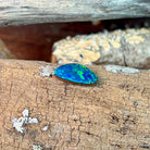 Profile view of the 2.46ct freeform opal doublet on lichen-flecked driftwood