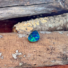 Close-up of the 3.53ct opal doublet on lichen-flecked driftwood
