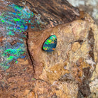 Green and gold play-of-colour across a 1.5ct freeform Australian opal doublet on rock