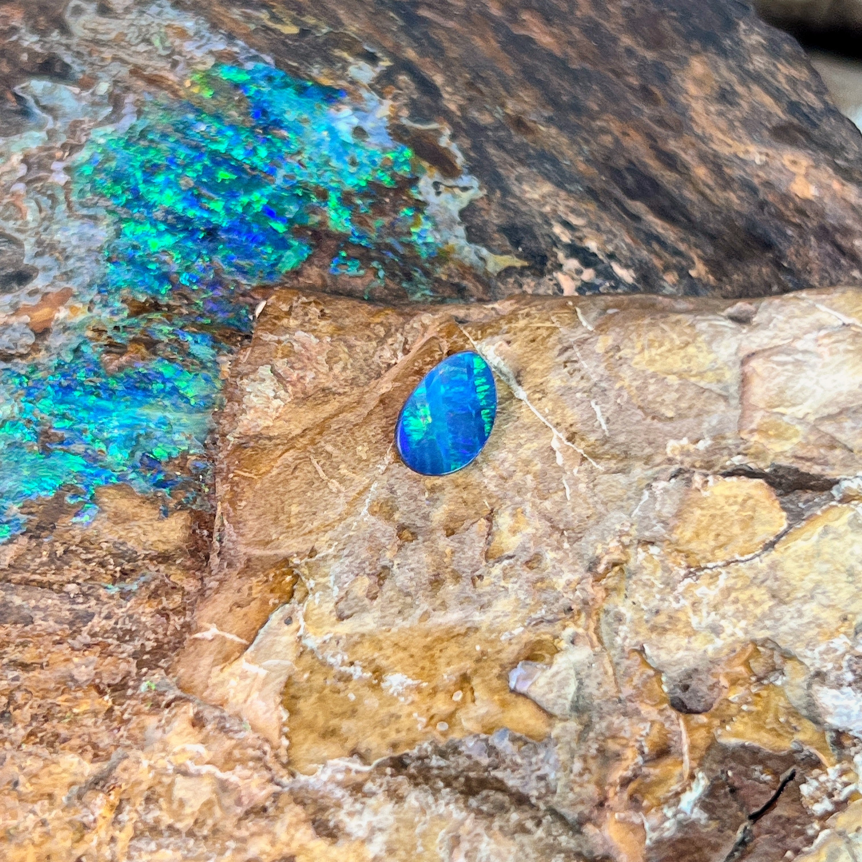 Green and blue play-of-colour in a 0.52ct Australian opal doublet, 7.7x5.2mm