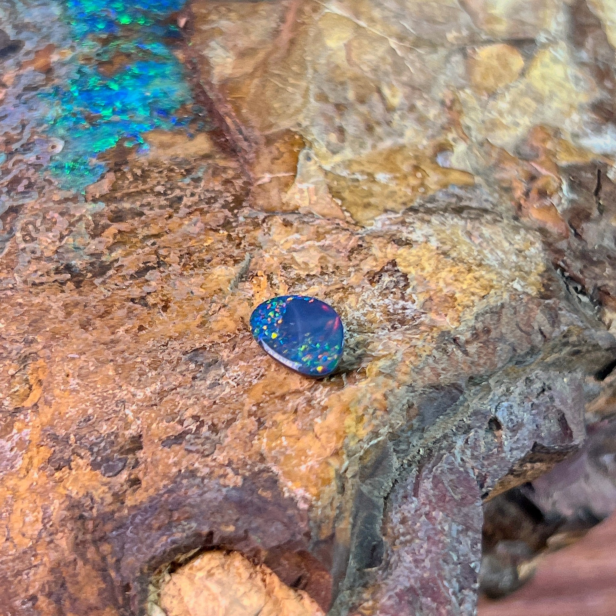 Pinfire play-of-colour scattered across a 0.78ct Australian opal doublet, 8.5x6.2mm