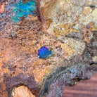 0.70ct Australian opal doublet on ironstone, rose flash across a blue violet body
