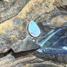 Australian crystal opal 1.15ct pear cabochon, 11.8x7.8mm, green and yellow, loose and unset, on rock