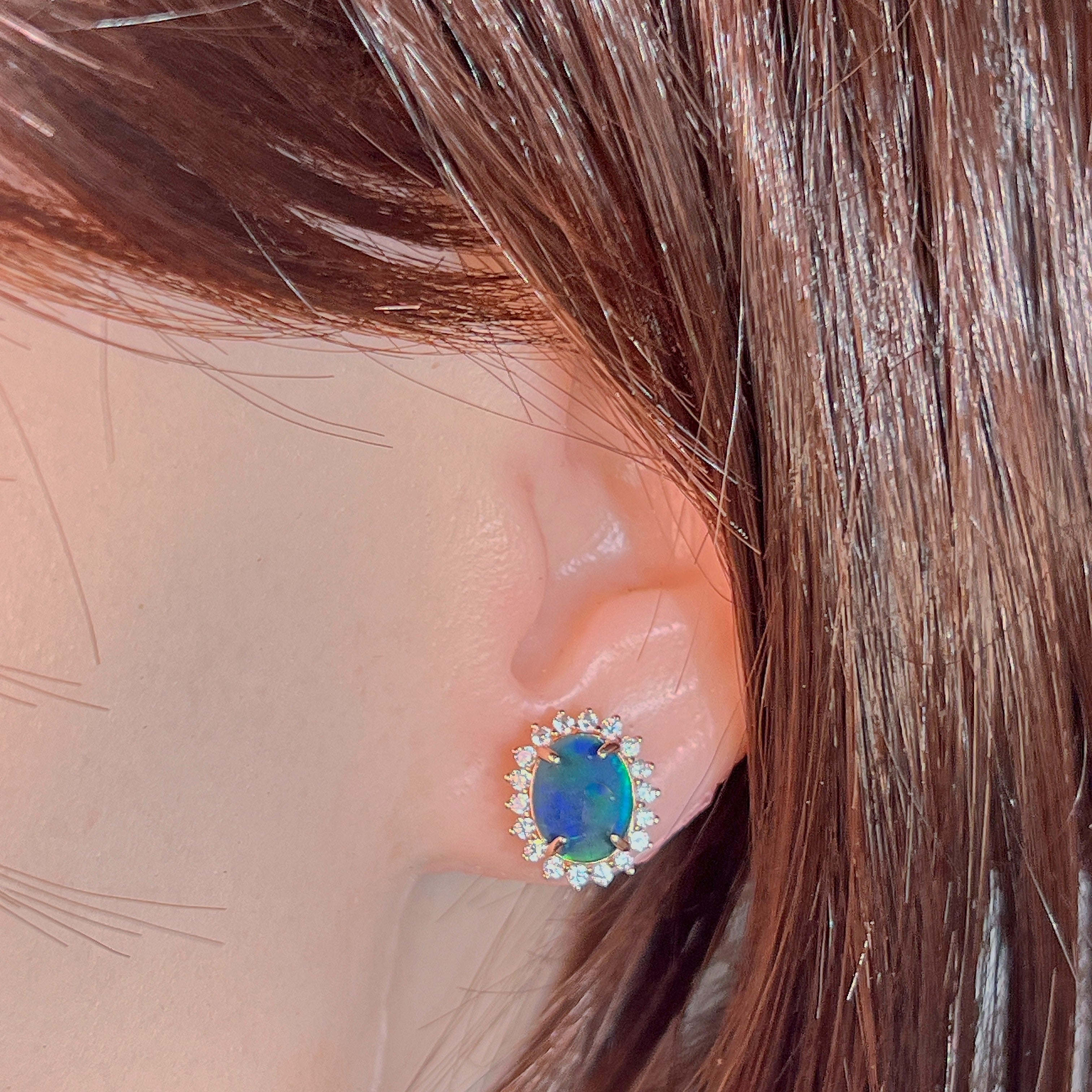 Rose gold-plated opal triplet halo stud earring worn on the ear, showing its scale