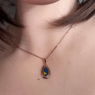 freeform Australian opal doublet pendant in rose gold-plated silver, worn at the neck