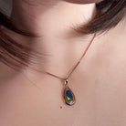 Australian opal doublet pendant worn at the neck, blue, green and red play-of-colour
