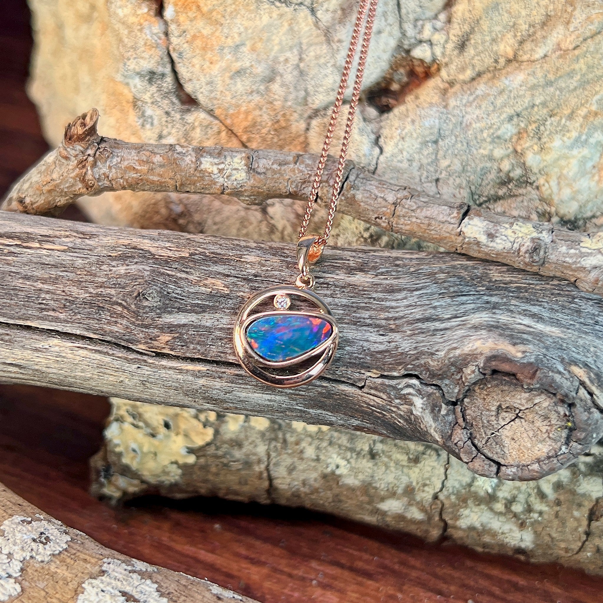 blue, yellow, green and red play-of-colour in a 12 x 11mm freeform Australian opal doublet pendant