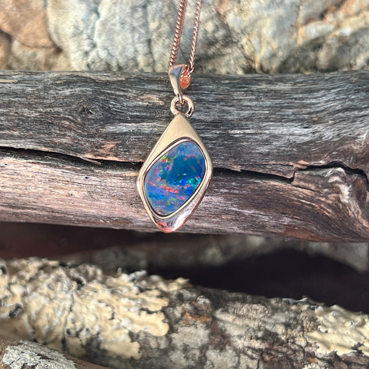 red, blue and green play-of-colour in a 12 x 9mm freeform Australian opal doublet pendant