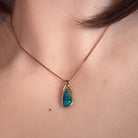 Worn Australian opal doublet pendant in rose gold-plated silver, green, red and blue, 12 x 6.5mm