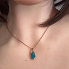freeform Australian opal doublet pendant worn, rose gold-plated silver, green, red and blue