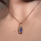 12 x 6.5mm freeform Australian opal doublet pendant worn at the neck, rose gold-plated silver