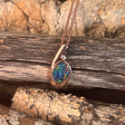 green, red and blue play-of-colour in an 11 x 8mm freeform Australian opal doublet pendant