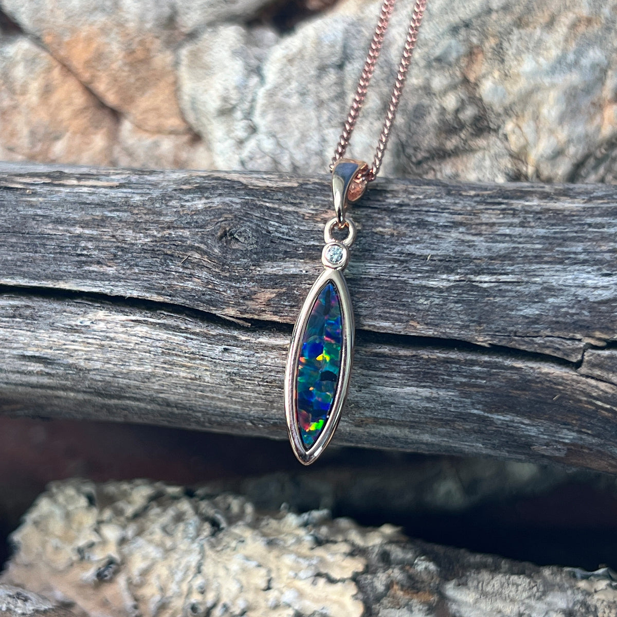 red, blue, green and violet play-of-colour in a 15 x 5mm marquise Australian opal doublet pendant