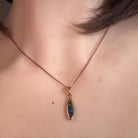 Worn Australian opal doublet pendant in rose gold-plated silver, red, blue, green and violet, 15 x 5mm