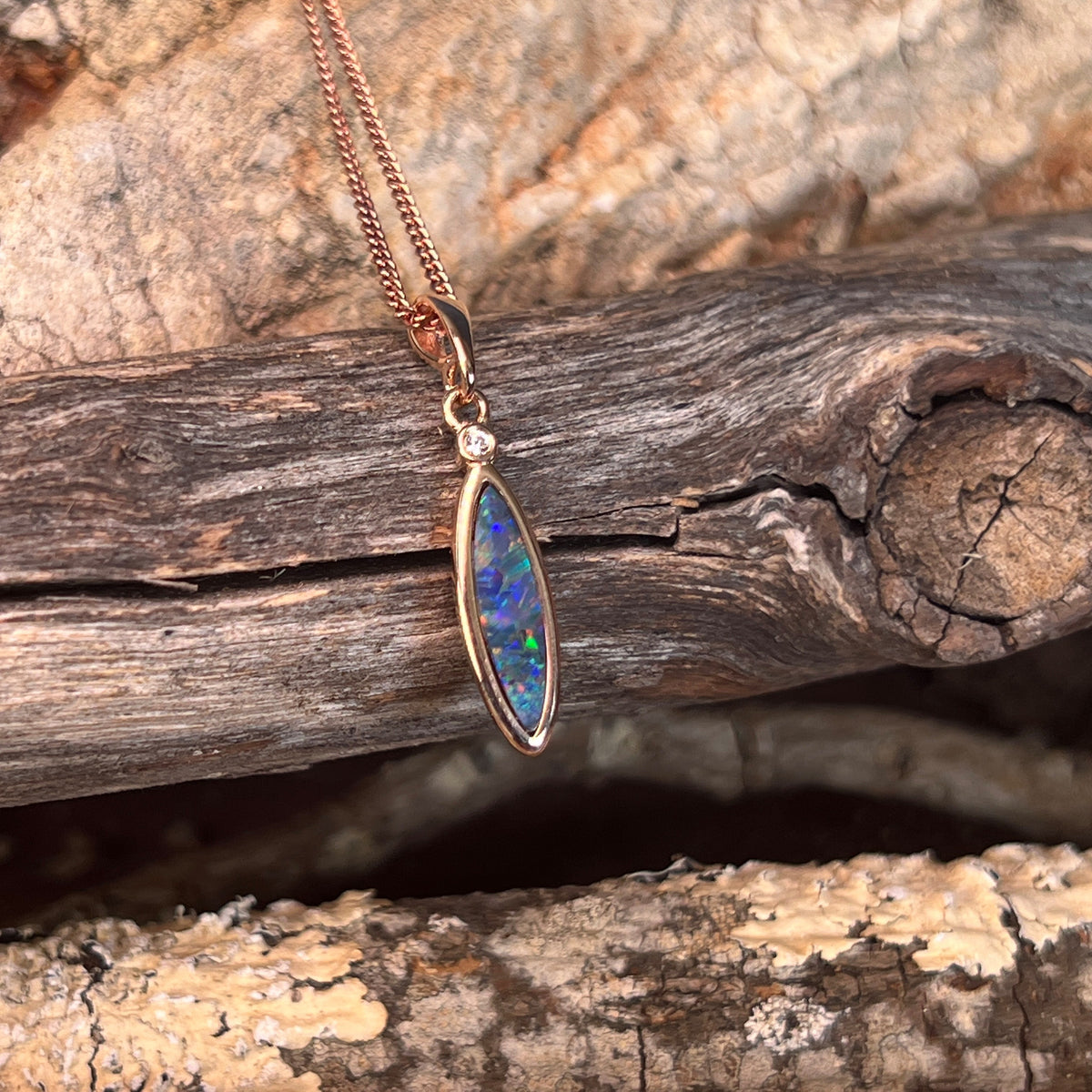 Australian opal doublet pendant, rose gold-plated silver, 16 x 5mm stone showing green, red, blue and yellow
