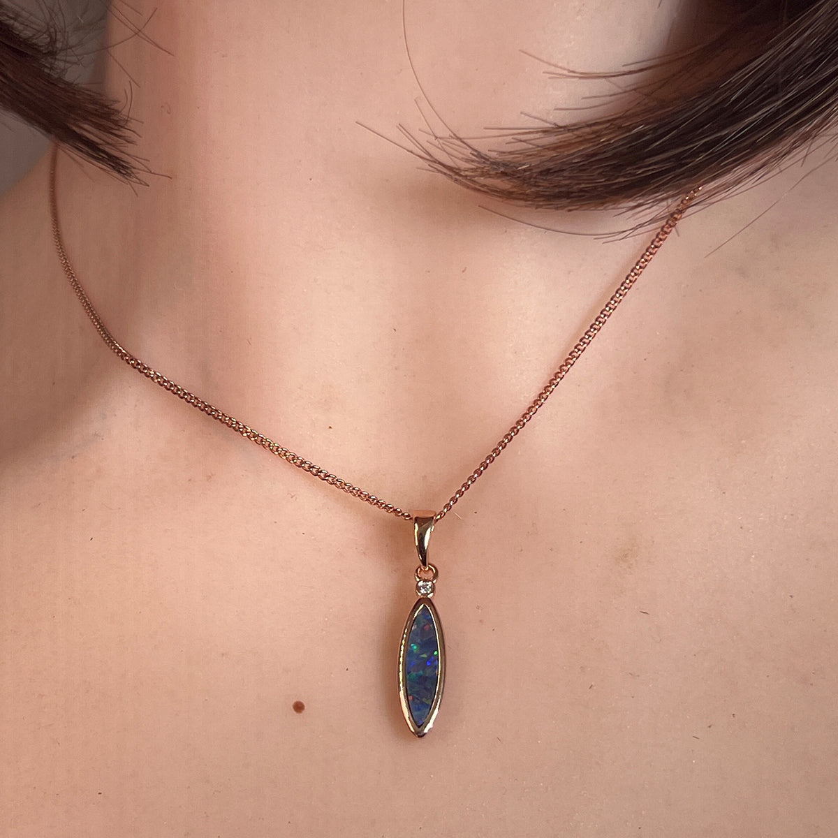 marquise Australian opal doublet pendant in rose gold-plated silver, worn at the neck
