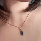 12 x 6.5mm oval Australian opal doublet pendant worn at the neck, rose gold-plated silver