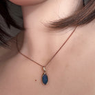 Worn Australian opal doublet pendant in rose gold-plated silver, red, blue, orange and green, 12 x 6.5mm