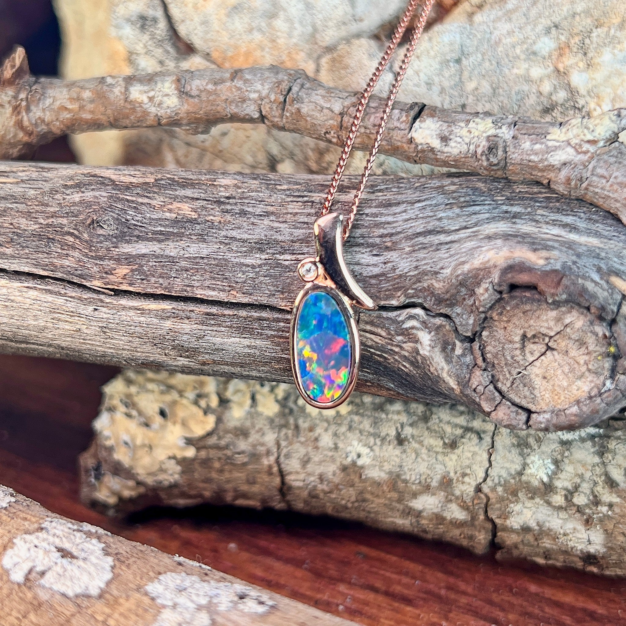 yellow, red, blue and green play-of-colour in a 13 x 7mm oval Australian opal doublet pendant