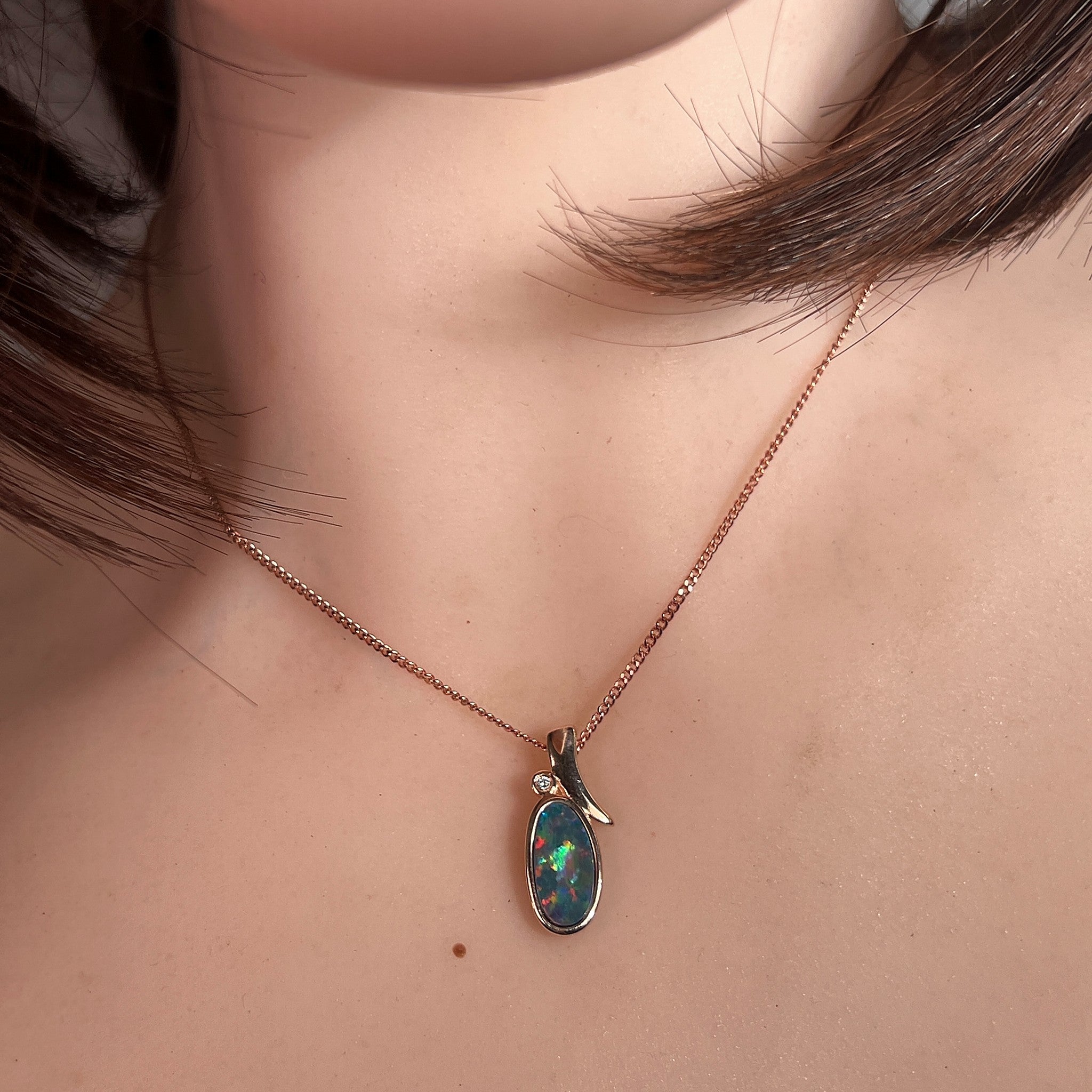 Australian opal doublet pendant worn at the neck, yellow, red, blue and green play-of-colour