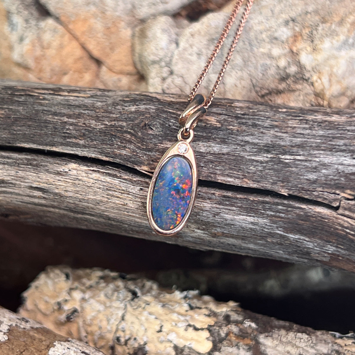 red and blue play-of-colour in a 12 x 6mm oval Australian opal doublet pendant