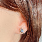 pear-shaped Australian opal doublet earrings in rose gold-plated silver, worn on the ear