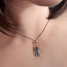Australian opal doublet pendant worn at the neck, blue, yellow, green and red play-of-colour
