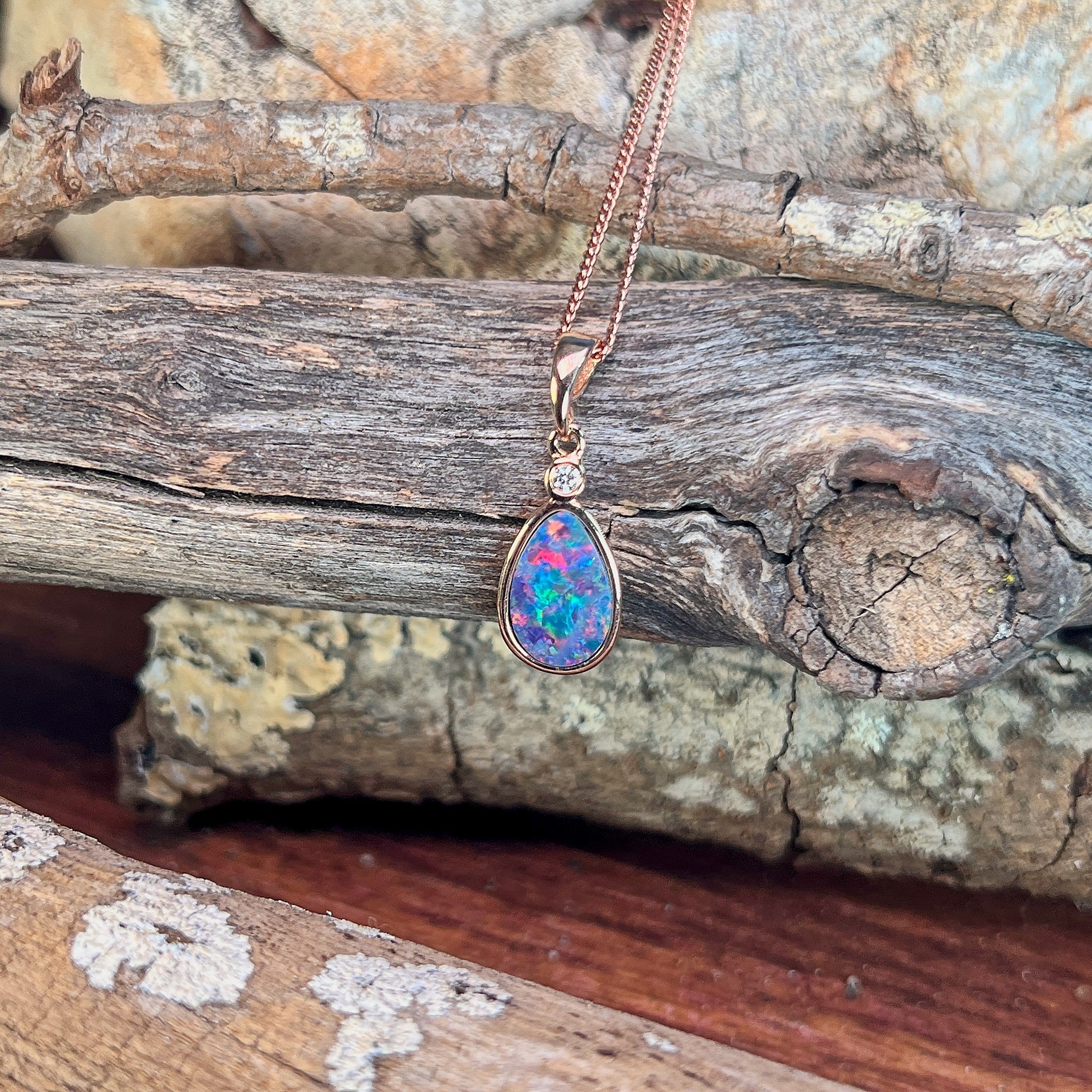 blue, red, yellow and green play-of-colour in a 11 x 7mm pear-shaped Australian opal doublet pendant